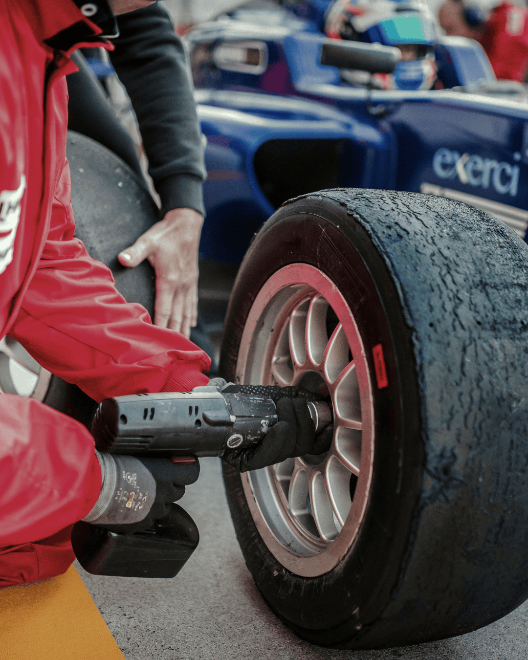 pit crew fixing a tyre