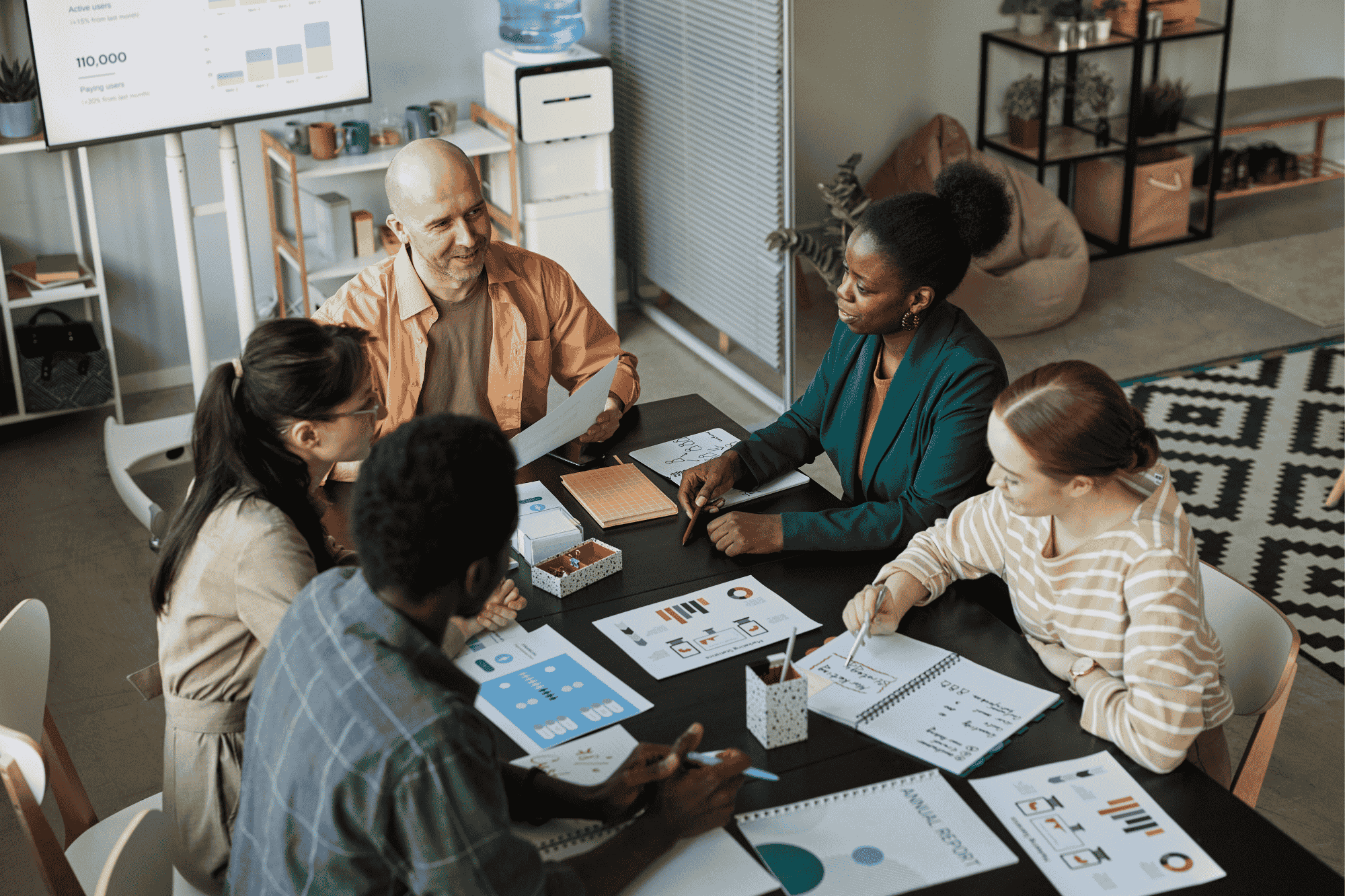 team meeting discussing annual report around a table