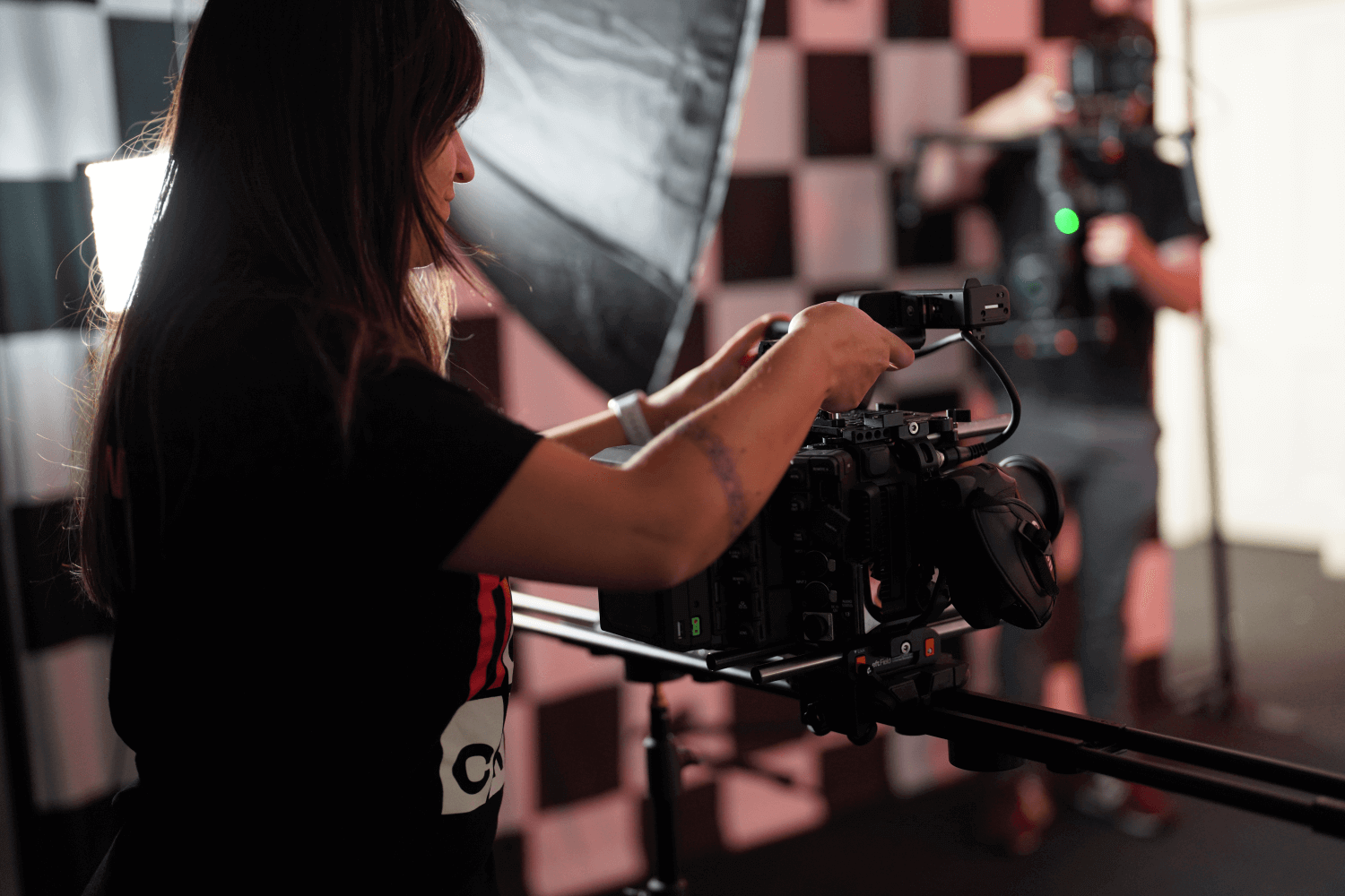 Videographer behind camera on a dolly track