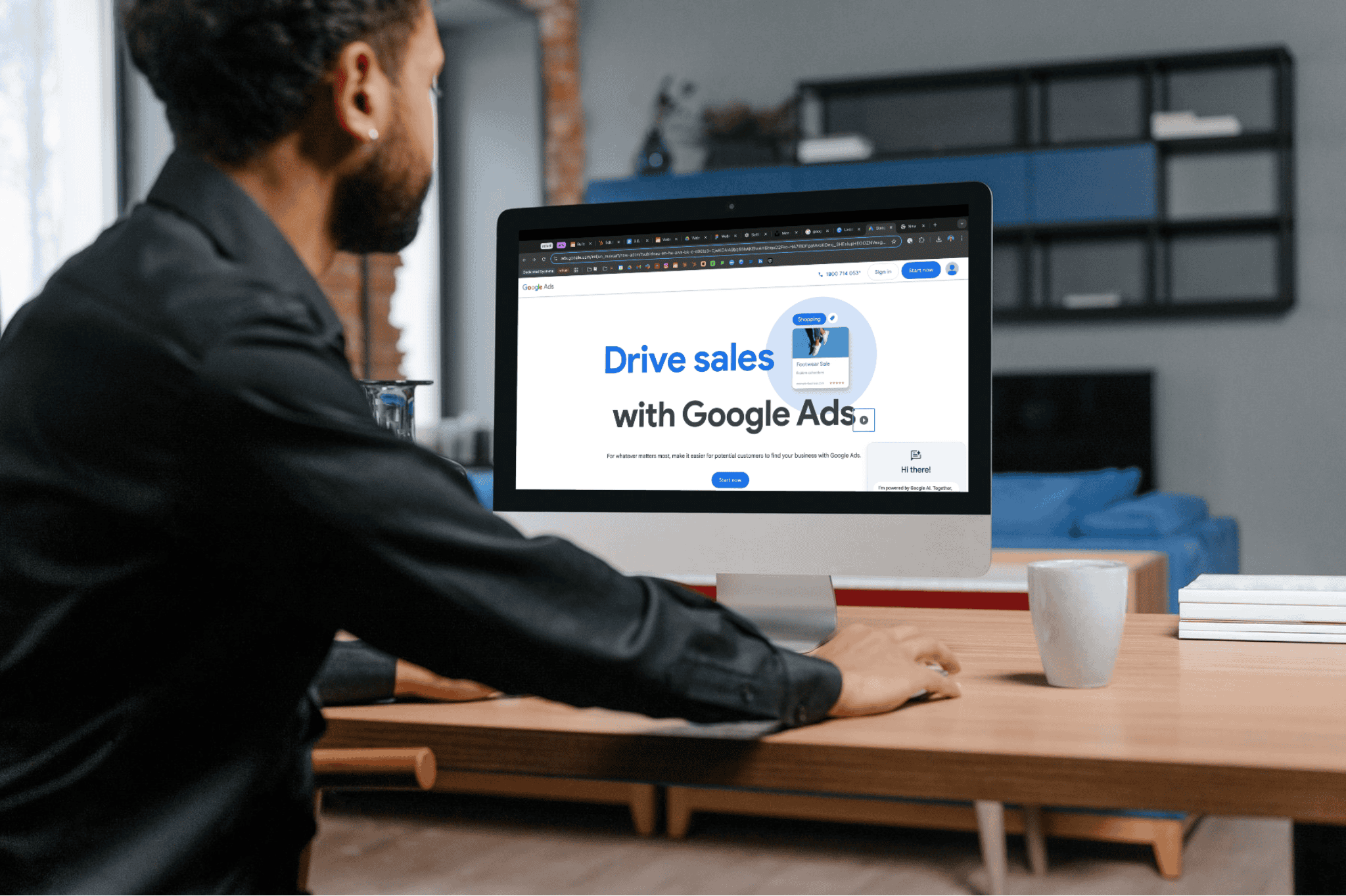 man looking at google ads website on desktop computer 